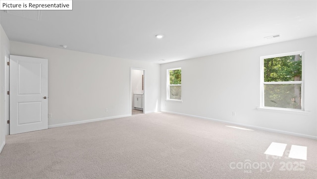 carpeted empty room with visible vents and baseboards