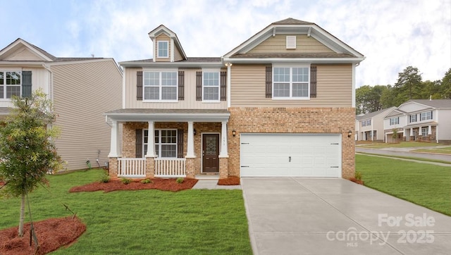 craftsman house with a porch, concrete driveway, a front lawn, a garage, and brick siding