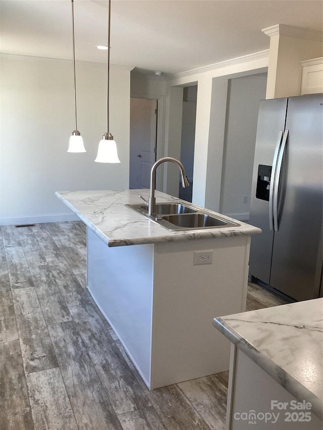 kitchen featuring white cabinetry, wood finished floors, stainless steel refrigerator with ice dispenser, and a sink