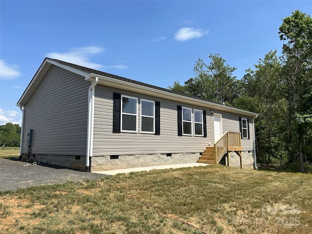 manufactured / mobile home featuring crawl space and a front lawn