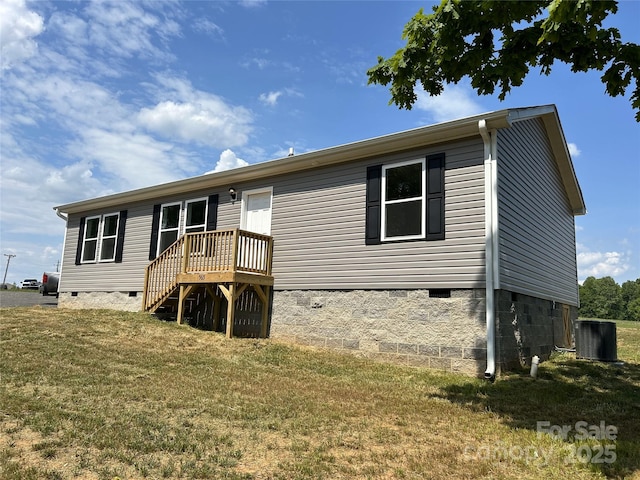 rear view of property with a lawn, central air condition unit, crawl space, and a deck