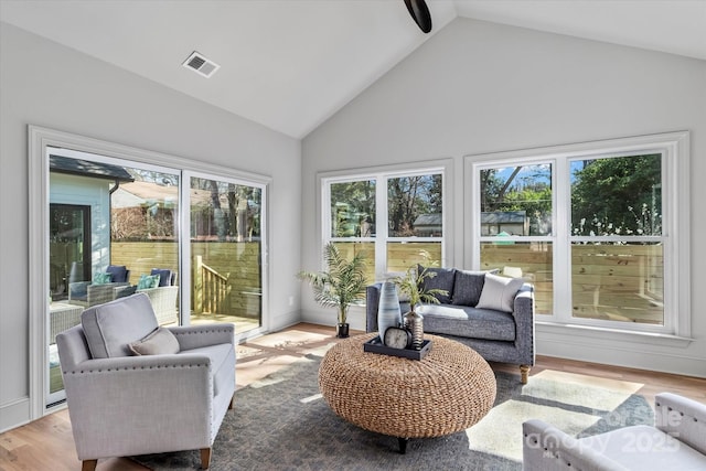 sunroom with lofted ceiling and visible vents