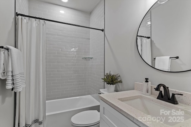 bathroom featuring shower / bath combo with shower curtain, toilet, and vanity