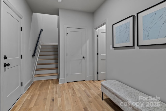 interior space with stairway and light wood-style flooring