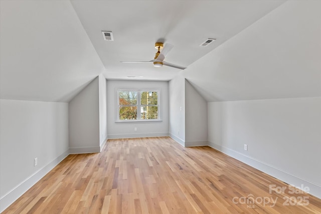 bonus room with visible vents, baseboards, a ceiling fan, and wood finished floors