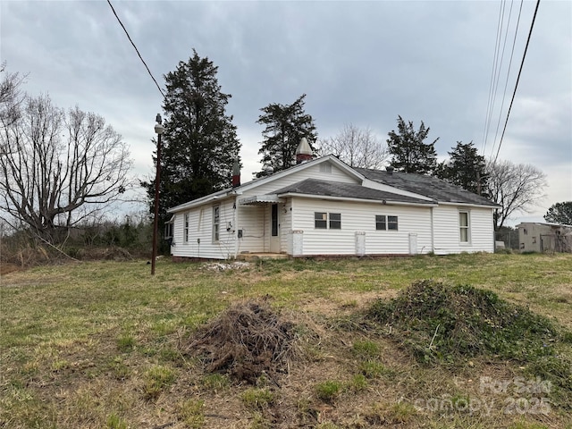 rear view of house with a lawn