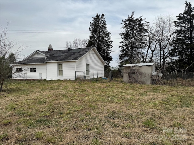 exterior space with an outbuilding and fence