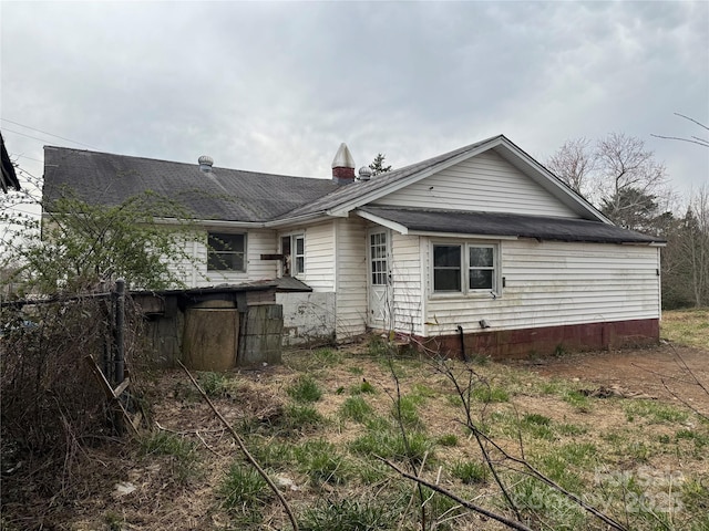 rear view of house with fence