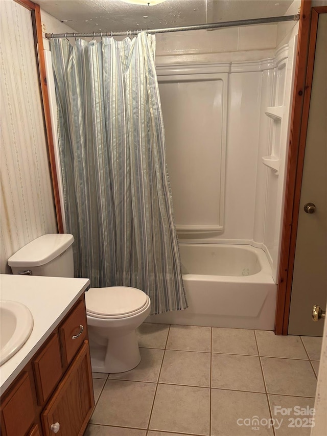 bathroom featuring toilet, shower / tub combo with curtain, vanity, and tile patterned flooring