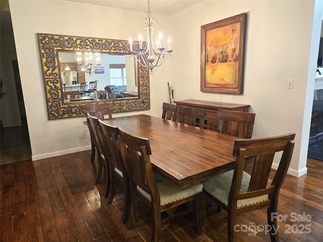 dining room featuring baseboards, dark wood-type flooring, a notable chandelier, and crown molding