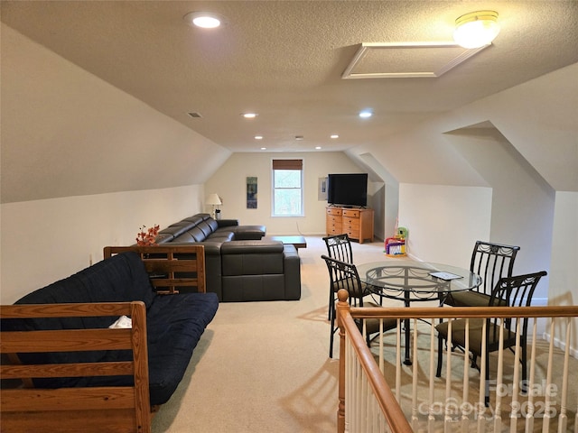 interior space featuring recessed lighting, a textured ceiling, attic access, and vaulted ceiling