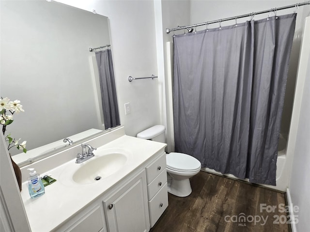 bathroom with toilet, vanity, shower / tub combo, and wood finished floors