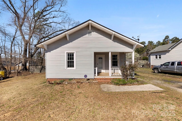 bungalow-style home featuring a porch and a front yard