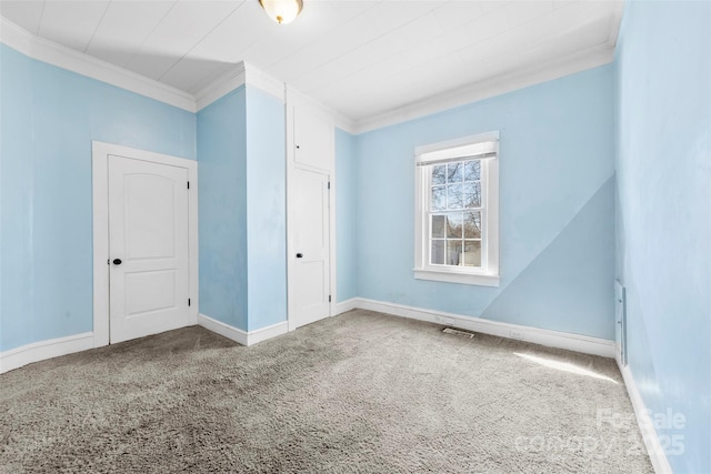 interior space featuring crown molding, carpet, visible vents, and baseboards