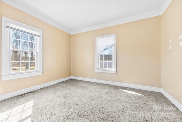 unfurnished room featuring visible vents, baseboards, and crown molding