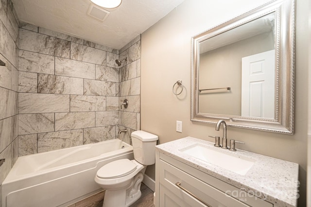 bathroom with vanity, toilet, visible vents, shower / tub combination, and wood finished floors