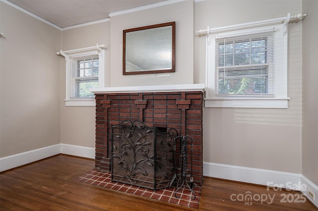 interior details with baseboards, wood finished floors, a fireplace, and ornamental molding