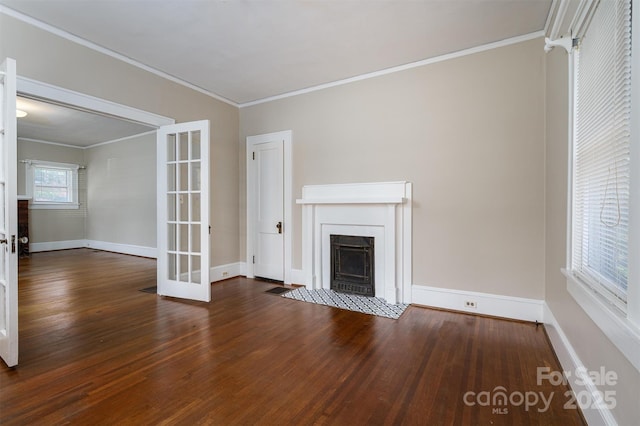 unfurnished living room with baseboards, a fireplace with flush hearth, wood finished floors, and ornamental molding