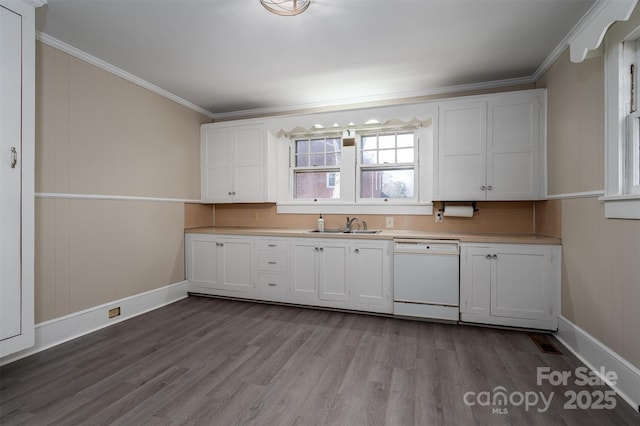 kitchen with dishwasher, light countertops, dark wood-style floors, white cabinets, and a sink