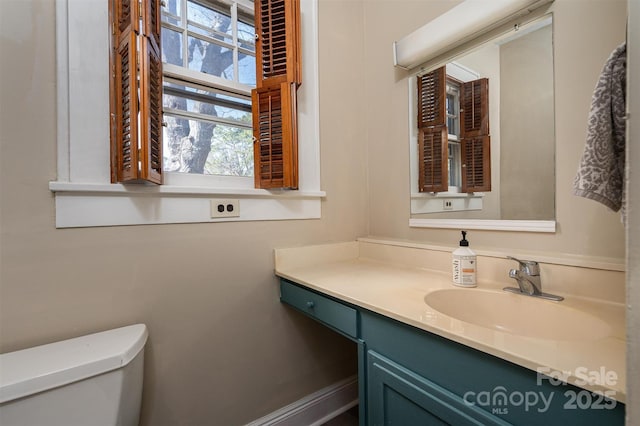 bathroom featuring vanity and toilet