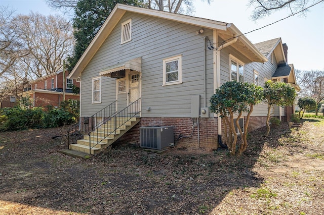 rear view of property with cooling unit