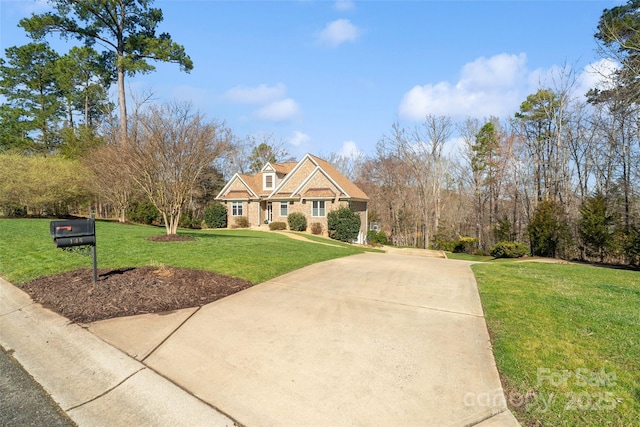 view of front of home featuring concrete driveway and a front yard