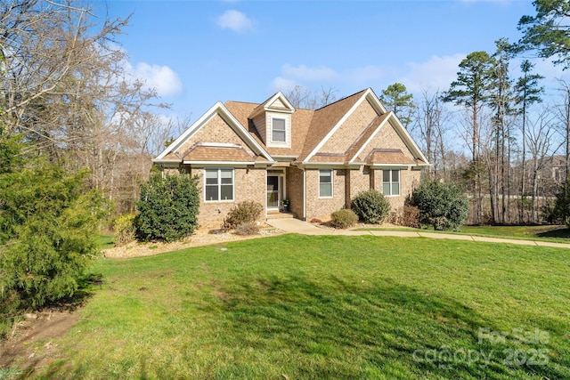 craftsman inspired home featuring brick siding and a front lawn