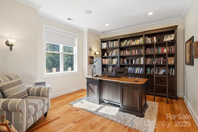 office area featuring light wood-type flooring, visible vents, baseboards, and ornamental molding