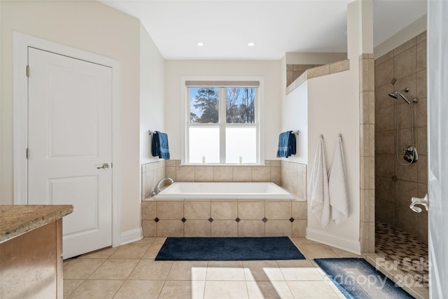 full bath featuring tile patterned floors, a walk in shower, and a garden tub