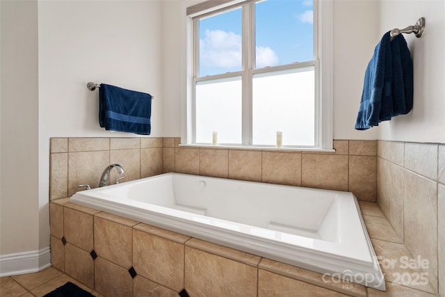 bathroom featuring tile patterned flooring and a garden tub