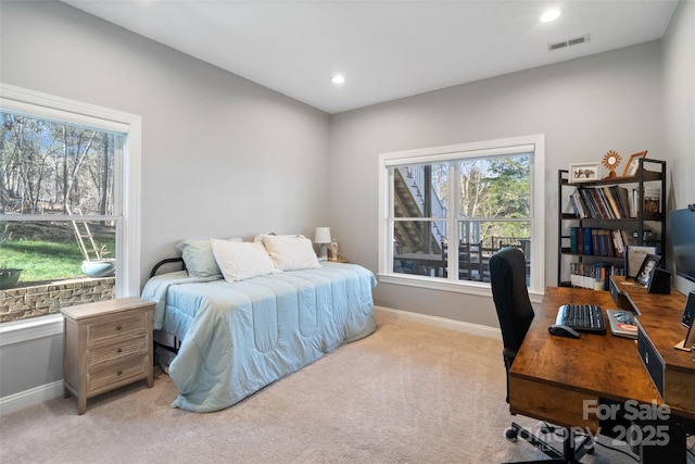 bedroom with recessed lighting, visible vents, light carpet, and baseboards