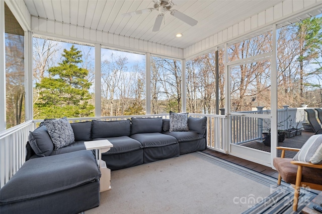 sunroom / solarium with a ceiling fan and a wealth of natural light