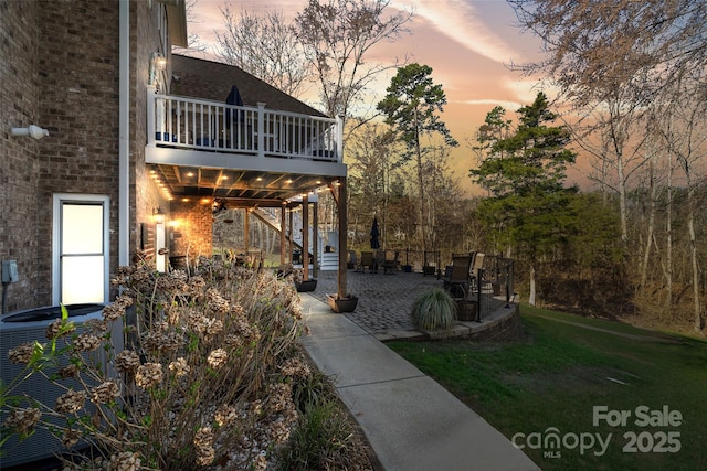 view of yard featuring stairway, central AC unit, and a patio area