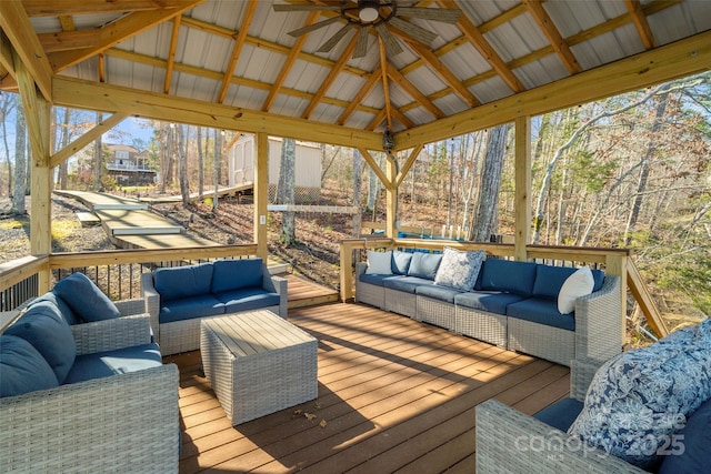 deck with a gazebo, an outdoor hangout area, and a ceiling fan