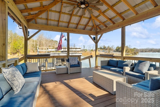 wooden terrace featuring a gazebo, an outdoor living space, a water view, and ceiling fan