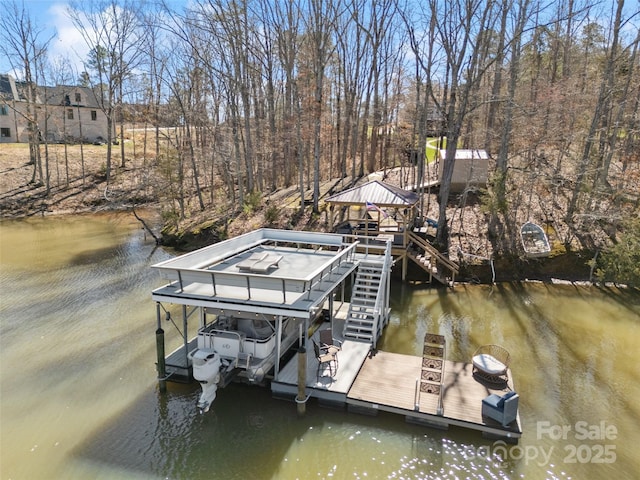 dock area with a gazebo, stairway, a water view, and boat lift