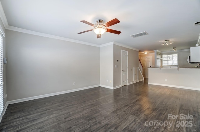 unfurnished living room with visible vents, dark wood-style flooring, a ceiling fan, and crown molding