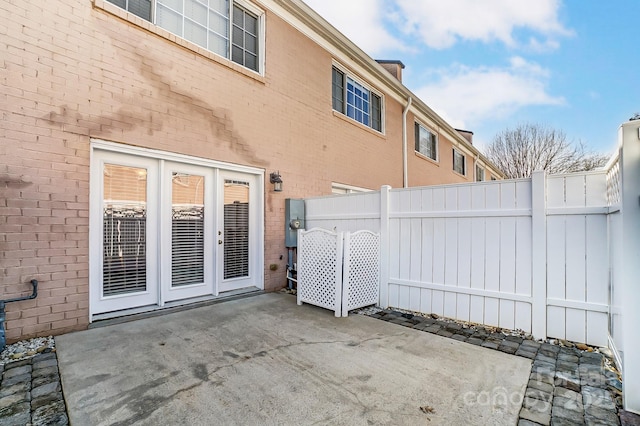 view of patio / terrace featuring french doors and fence