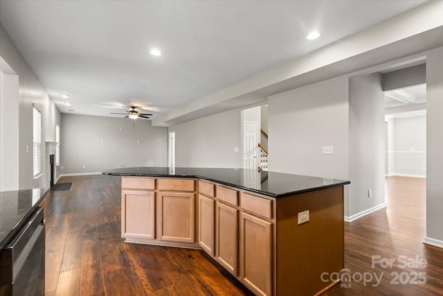 kitchen with stainless steel dishwasher, dark wood-style floors, a kitchen island, and ceiling fan