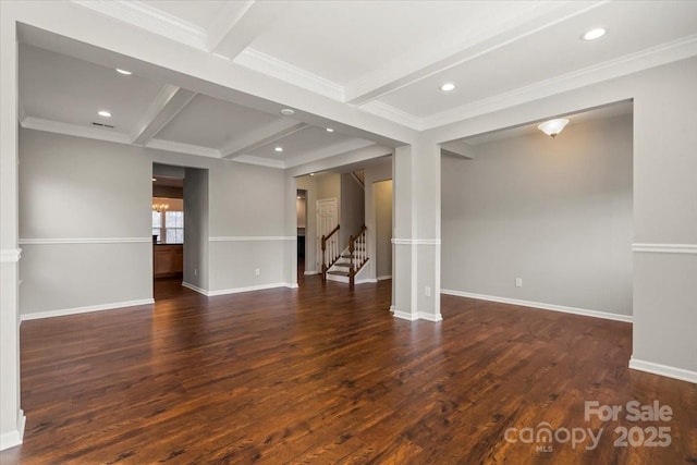 empty room featuring beam ceiling, recessed lighting, baseboards, and wood finished floors