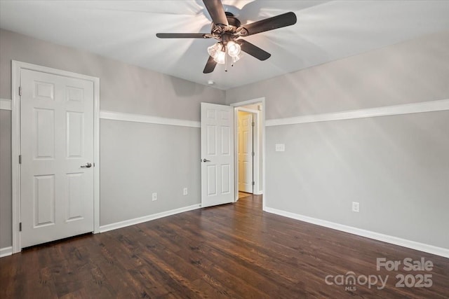 unfurnished bedroom featuring baseboards, wood finished floors, and a ceiling fan