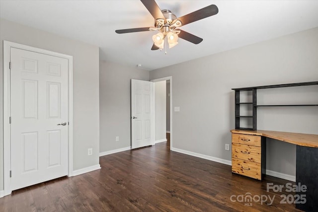 unfurnished bedroom with dark wood finished floors, ceiling fan, and baseboards