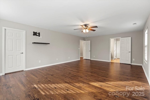 interior space featuring dark wood-type flooring, baseboards, and ceiling fan