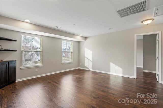 unfurnished living room with visible vents, recessed lighting, dark wood-type flooring, and baseboards