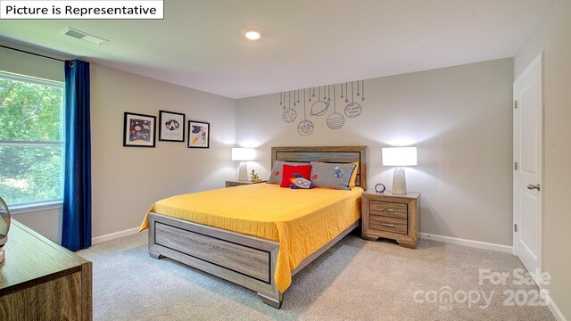 bedroom featuring visible vents, multiple windows, baseboards, and carpet