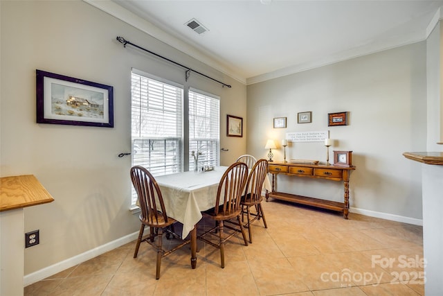 dining area with light tile patterned flooring, visible vents, crown molding, and baseboards