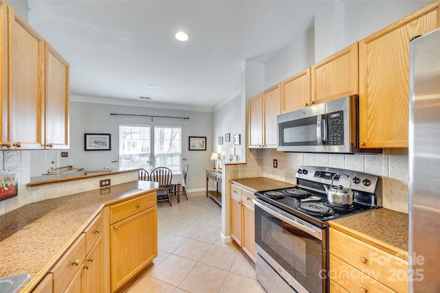 kitchen with light tile patterned floors, light brown cabinetry, decorative backsplash, stainless steel appliances, and crown molding