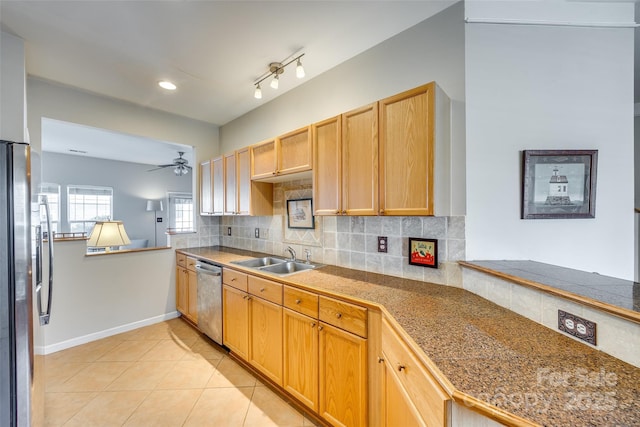 kitchen with backsplash, light tile patterned floors, stainless steel appliances, a ceiling fan, and a sink