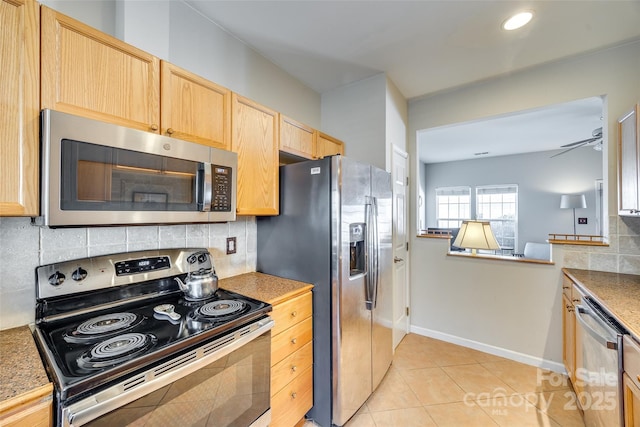 kitchen featuring light tile patterned floors, a ceiling fan, light brown cabinets, stainless steel appliances, and tasteful backsplash