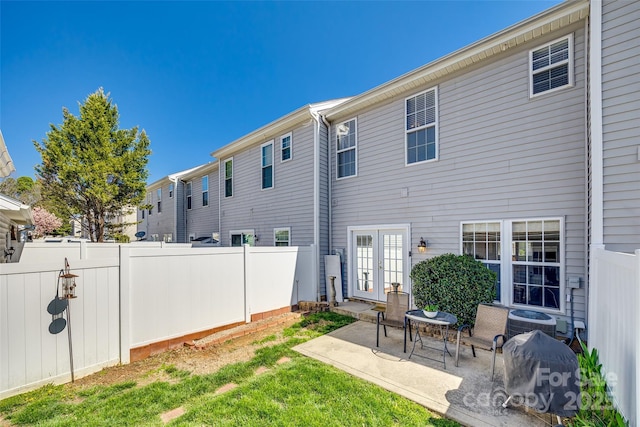 back of house with a patio area, central AC unit, french doors, and a fenced backyard